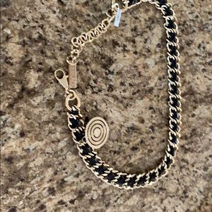 Versace gold chain and black leather belt.